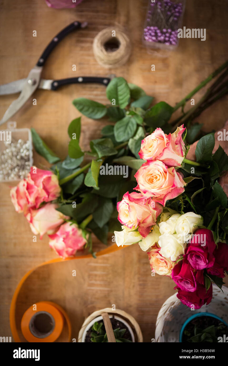 Bouquet of flower material on a wooden worktop Stock Photo