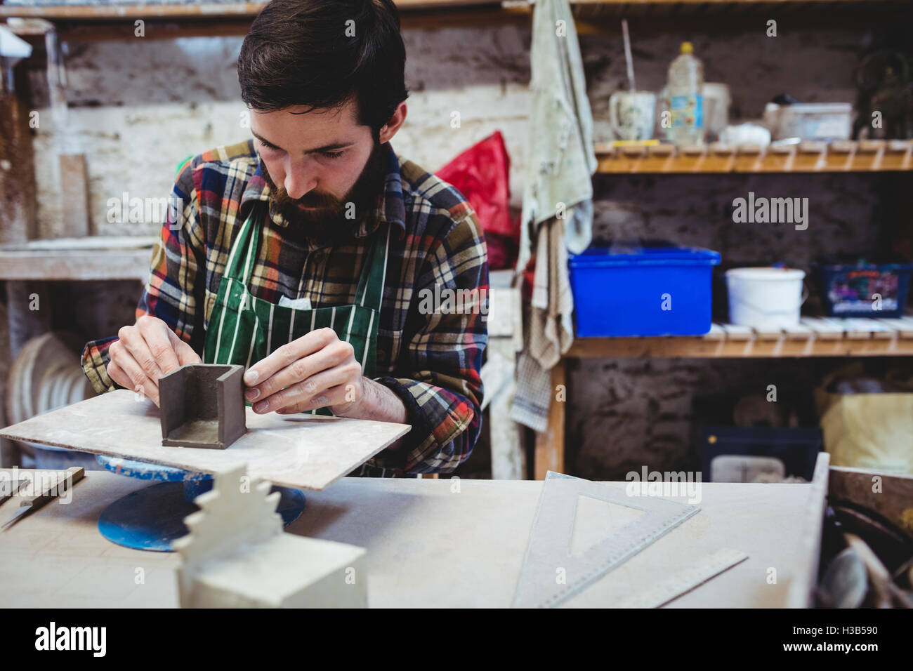 Concentrated man working at workshop Stock Photo - Alamy