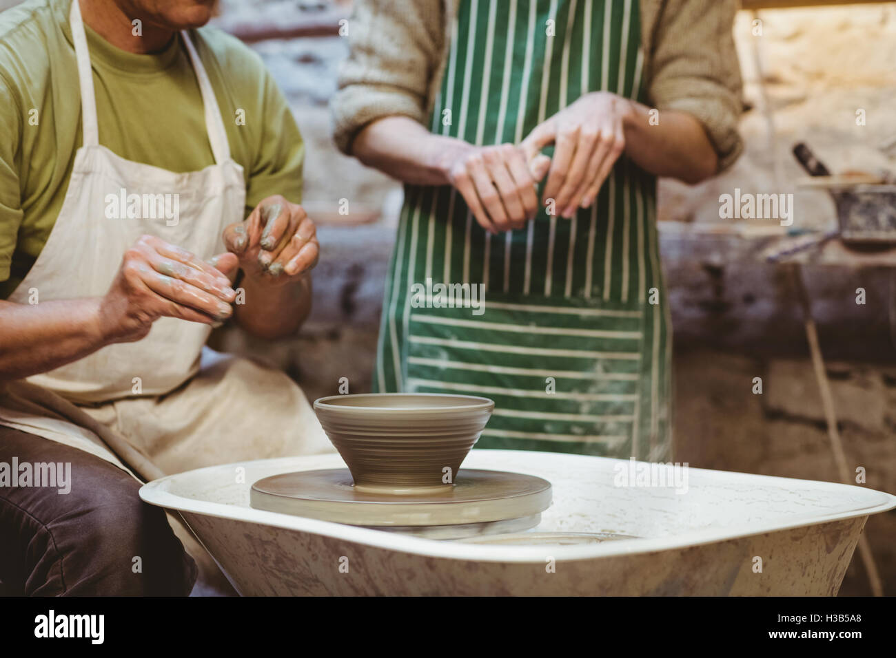 Midsection of potters working Stock Photo - Alamy