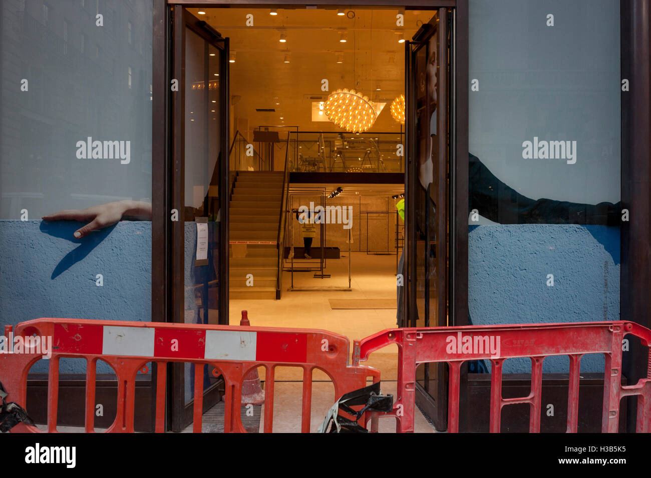 A workman seen through the open doorway of a new Jigsaw shop in central London Stock Photo Alamy