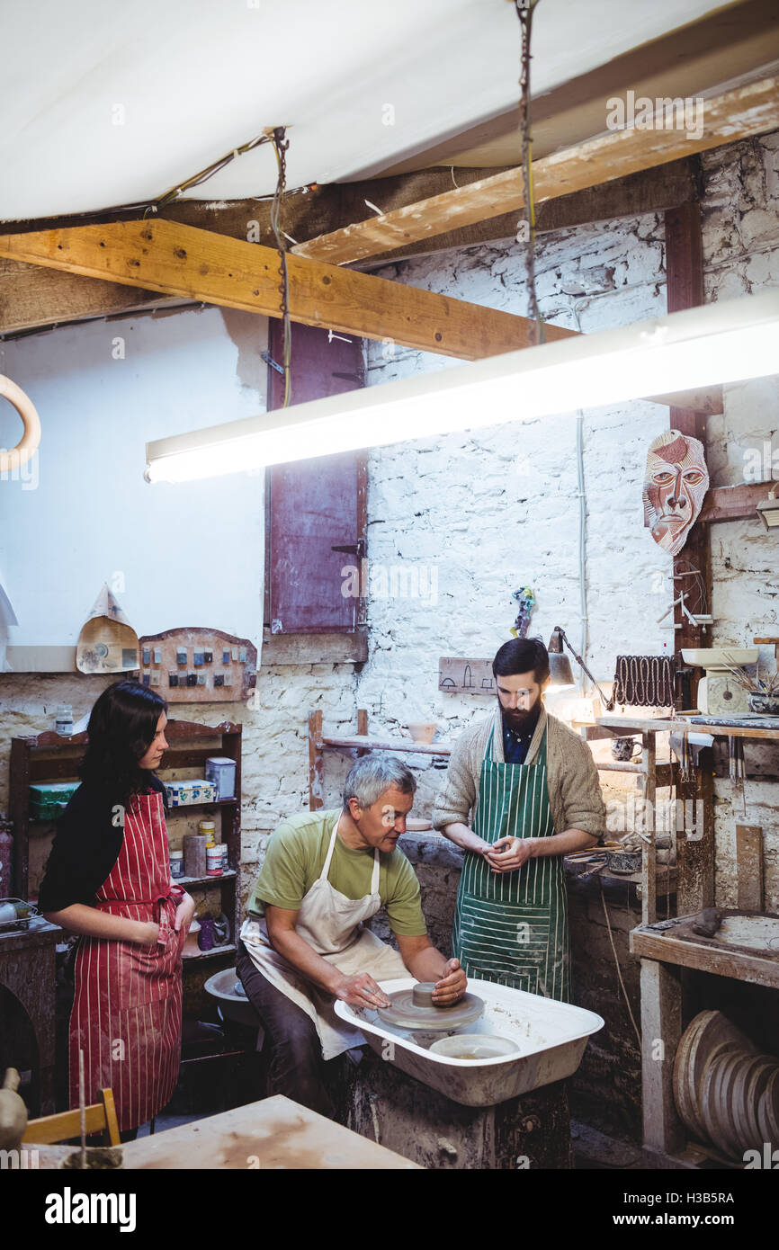 Team of potters in illuminated workshop Stock Photo - Alamy