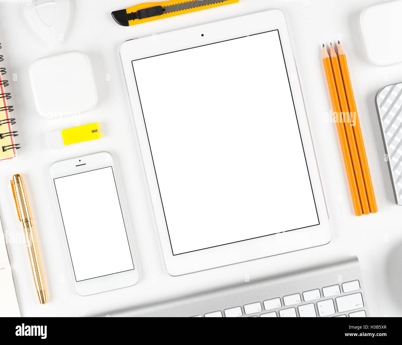 Responsive design: Keyboard, tablet and smartphone on white table Stock ...