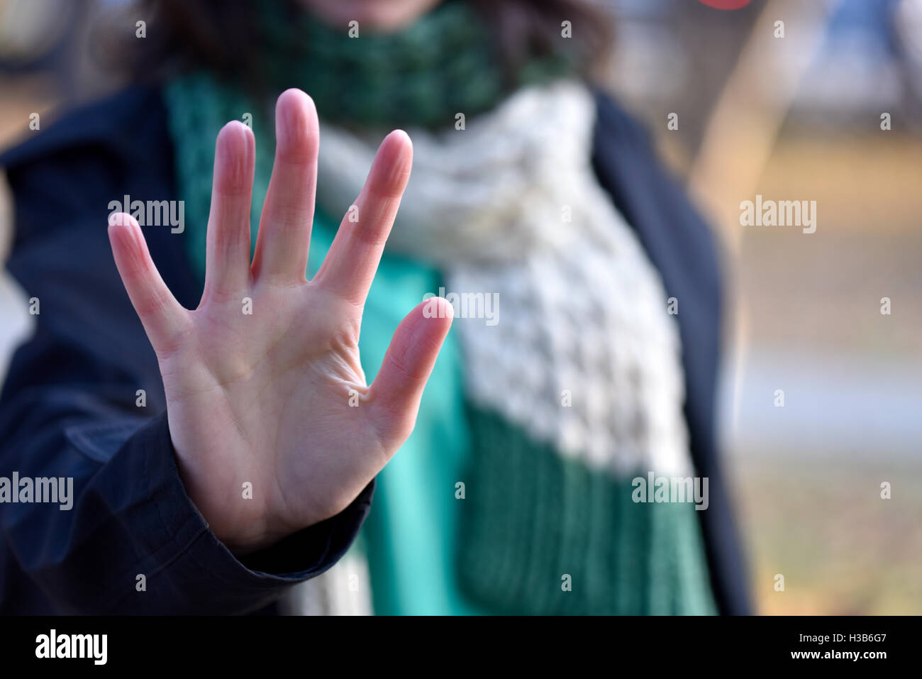 Woman put forth a hand in stopping gesture Stock Photo