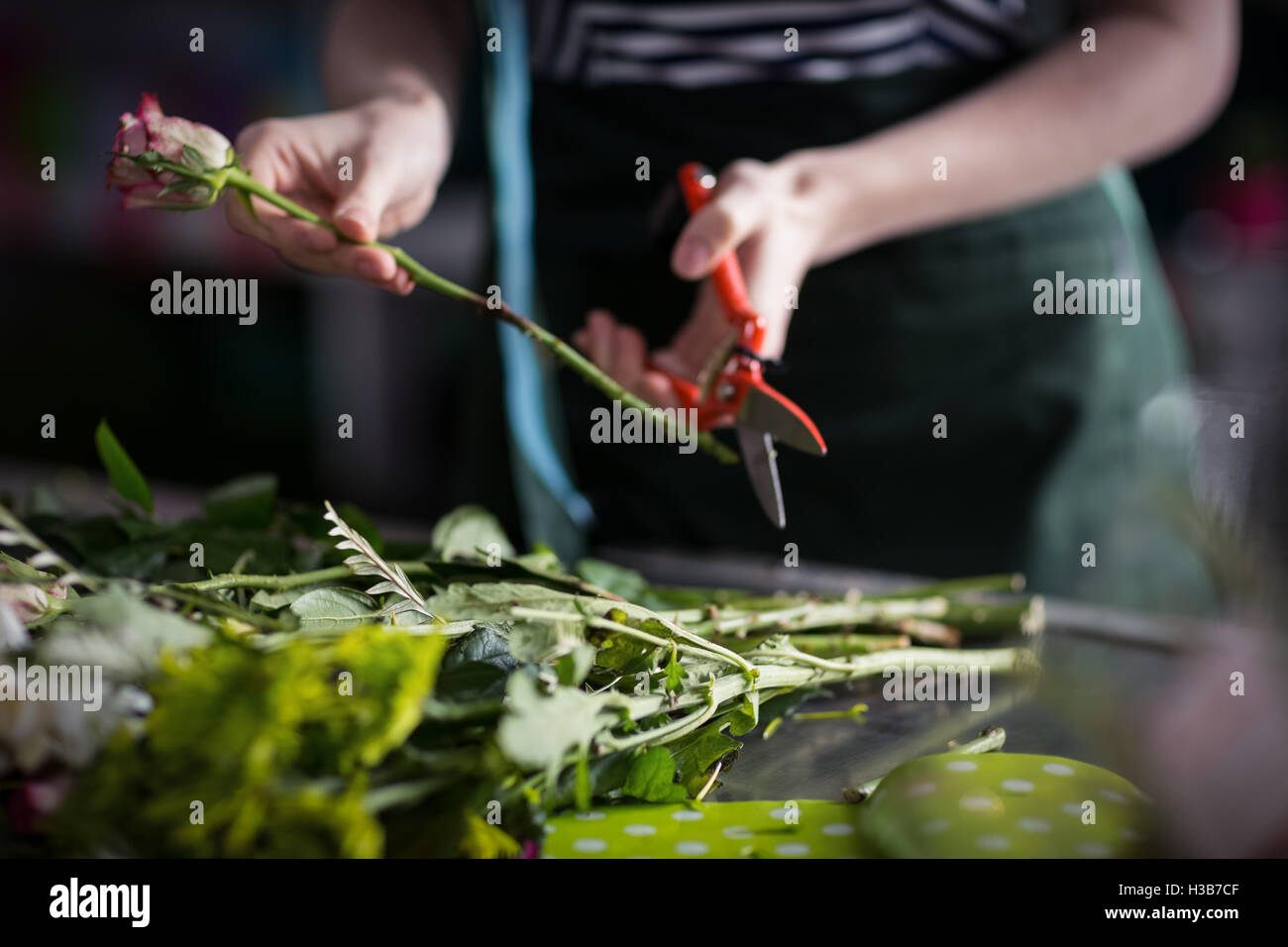 Female florist preparing flower bouquet Stock Photo - Alamy