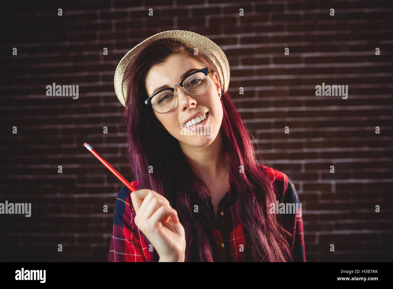 Young woman holding a pencil Stock Photo - Alamy