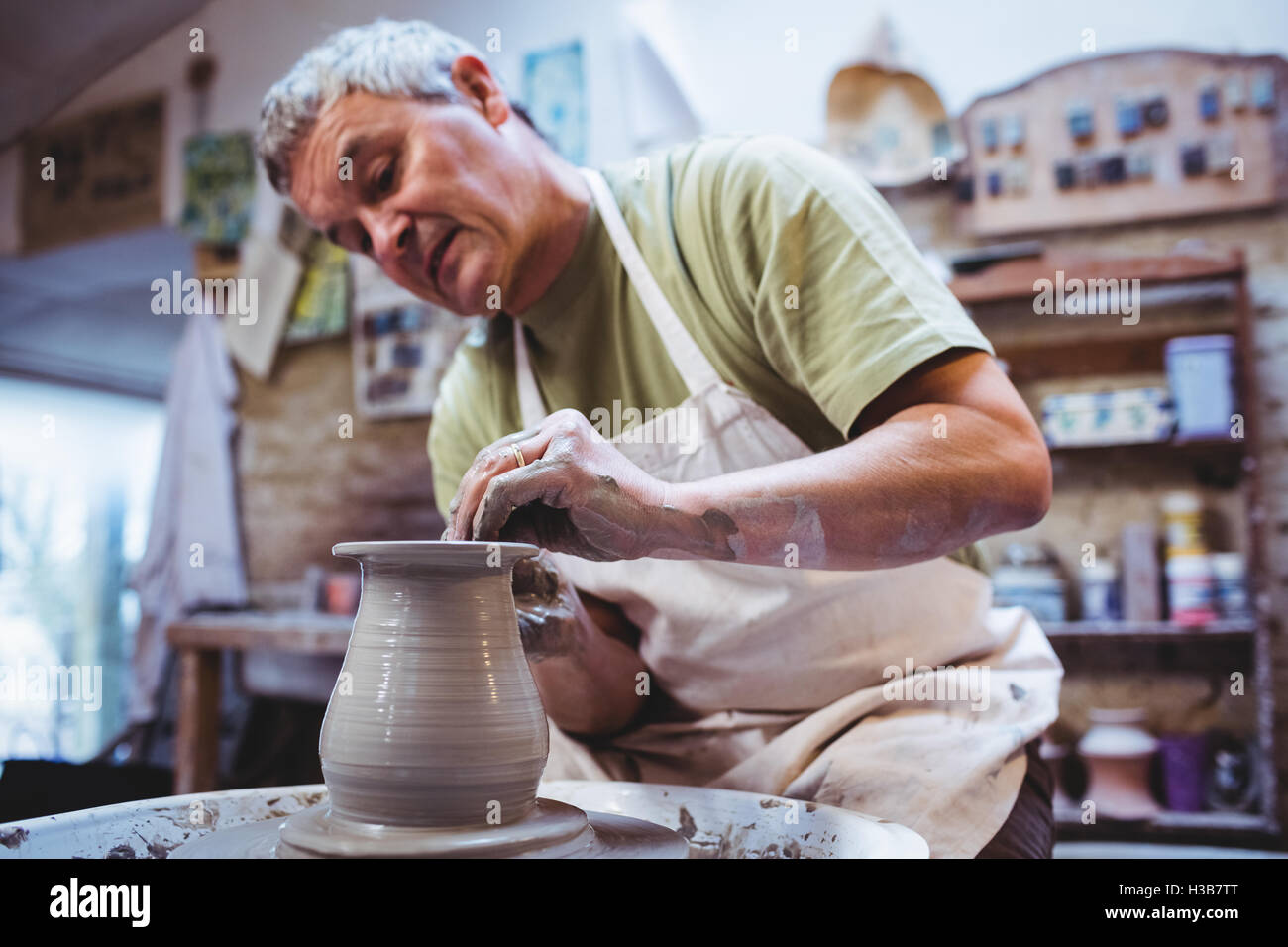 Craftsperson making container in pottery workshop Stock Photo - Alamy