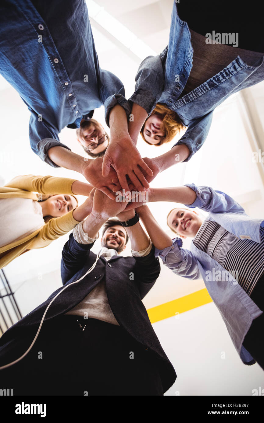 Smiling business people hand stacking in office Stock Photo Alamy
