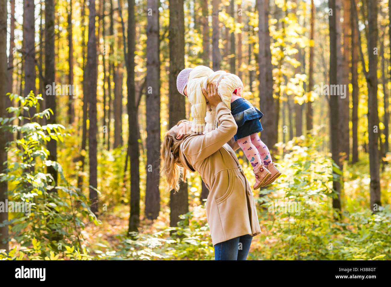Happy family playing in autumn park Stock Photo - Alamy