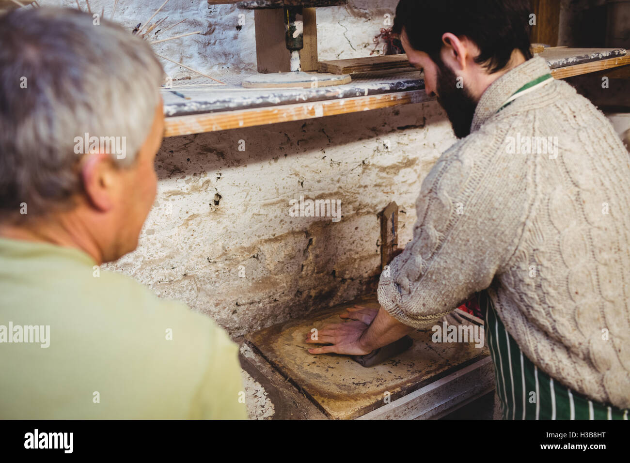 Male potters working in pottery workshop Stock Photo - Alamy