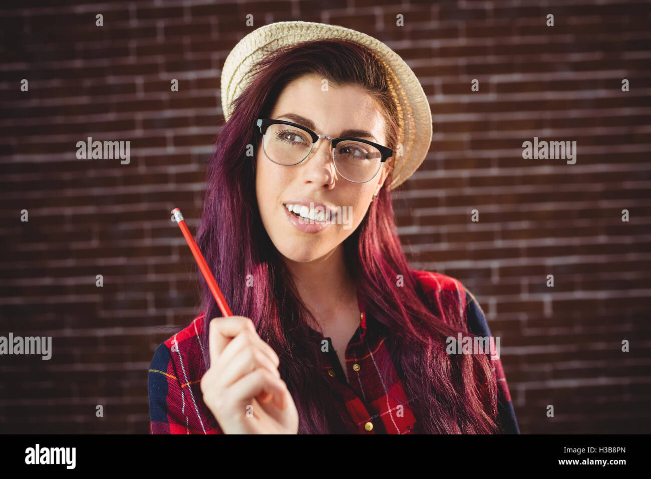 Young woman holding a pencil Stock Photo - Alamy