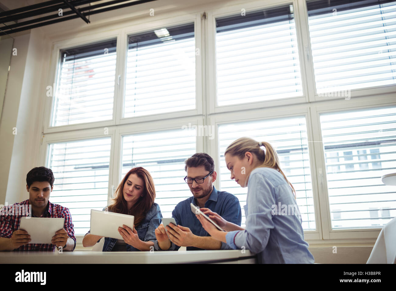 Business people using electronic devices Stock Photo Alamy