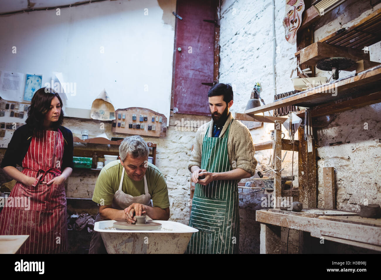 Concentrated team of potters in workshop Stock Photo - Alamy