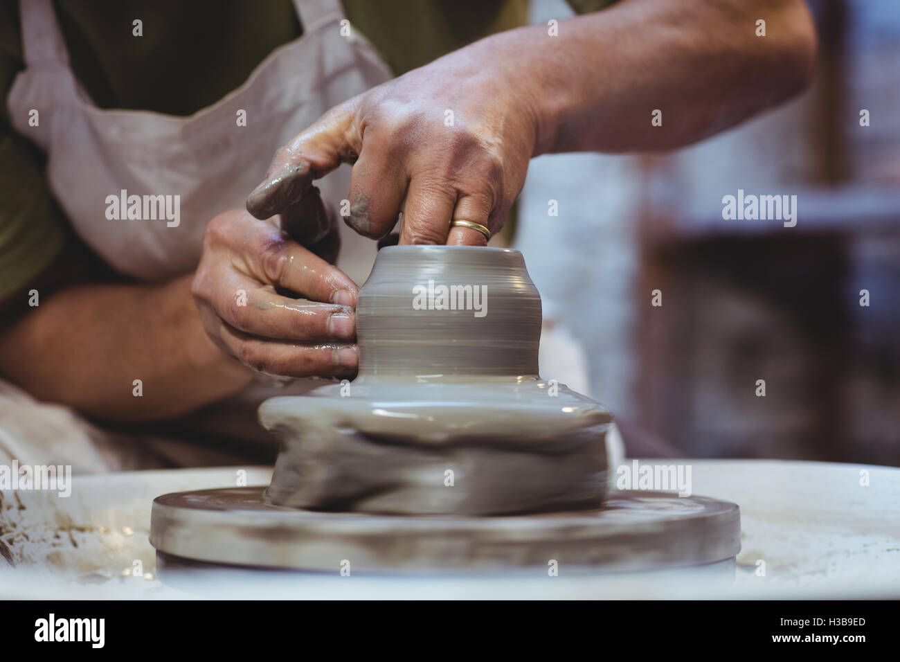 Artist working in pottery workshop Stock Photo - Alamy
