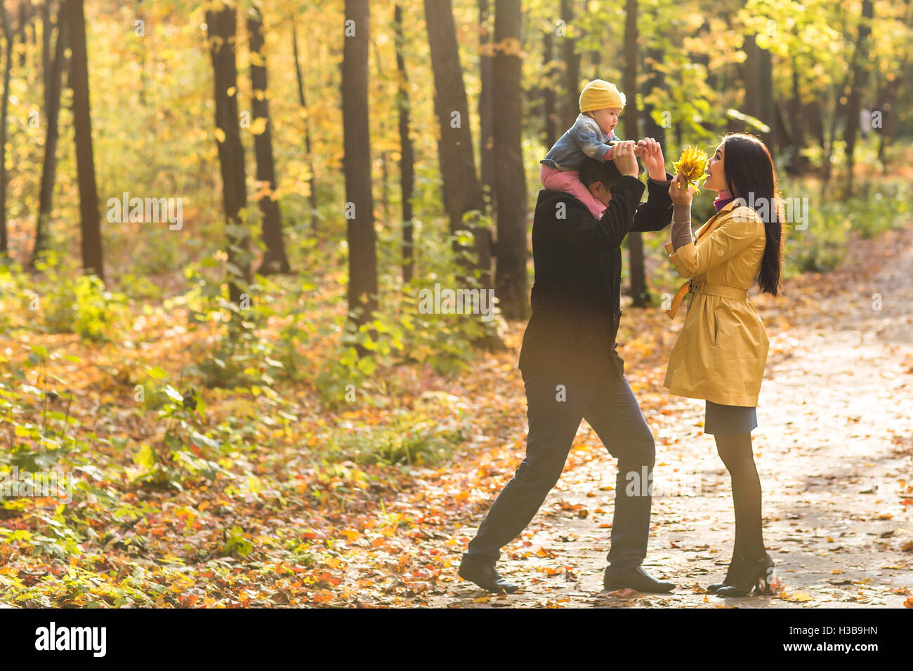 Happy family playing in autumn park Stock Photo - Alamy