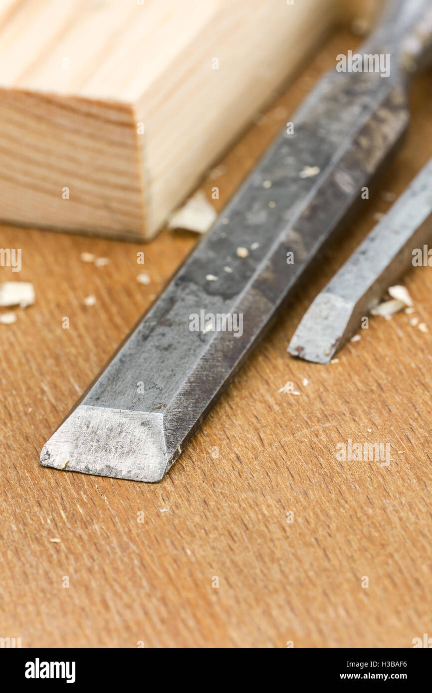 Used carpenter wood chisels tool with planks and shavings Stock Photo