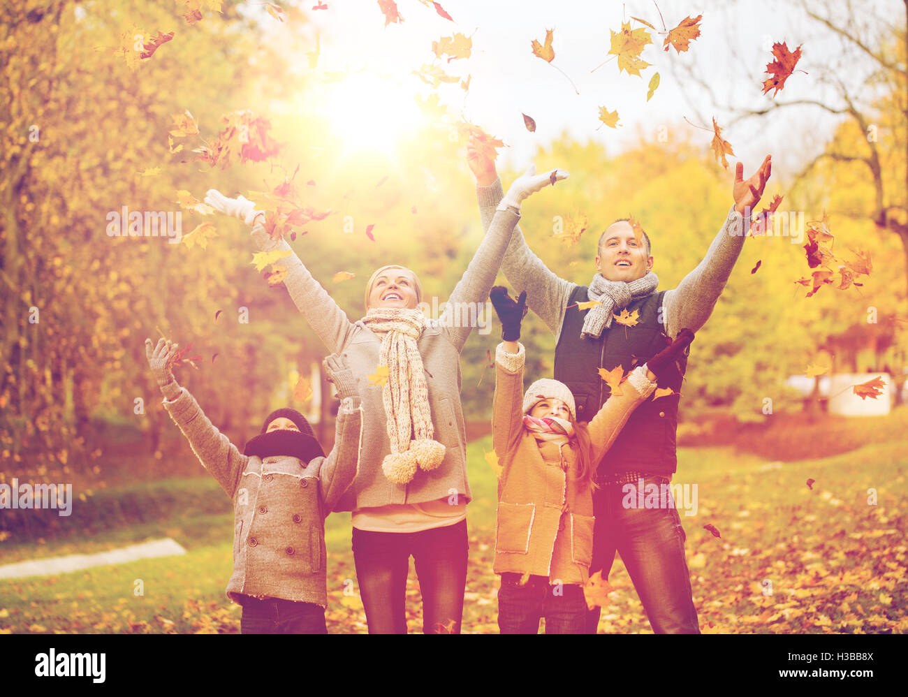 happy family playing with autumn leaves in park Stock Photo - Alamy