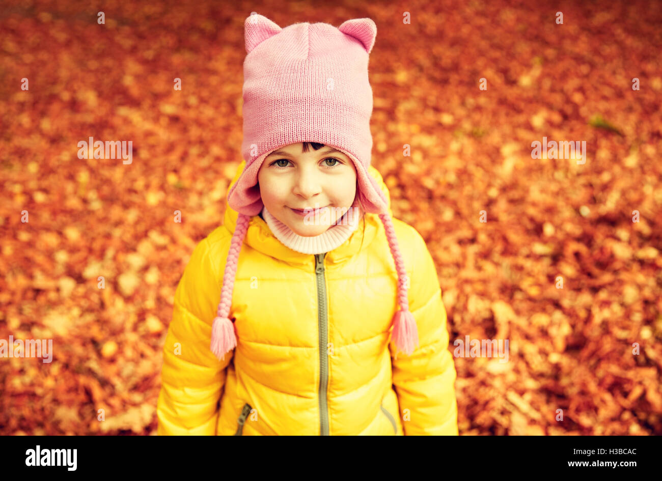 happy little girl in autumn park Stock Photo - Alamy