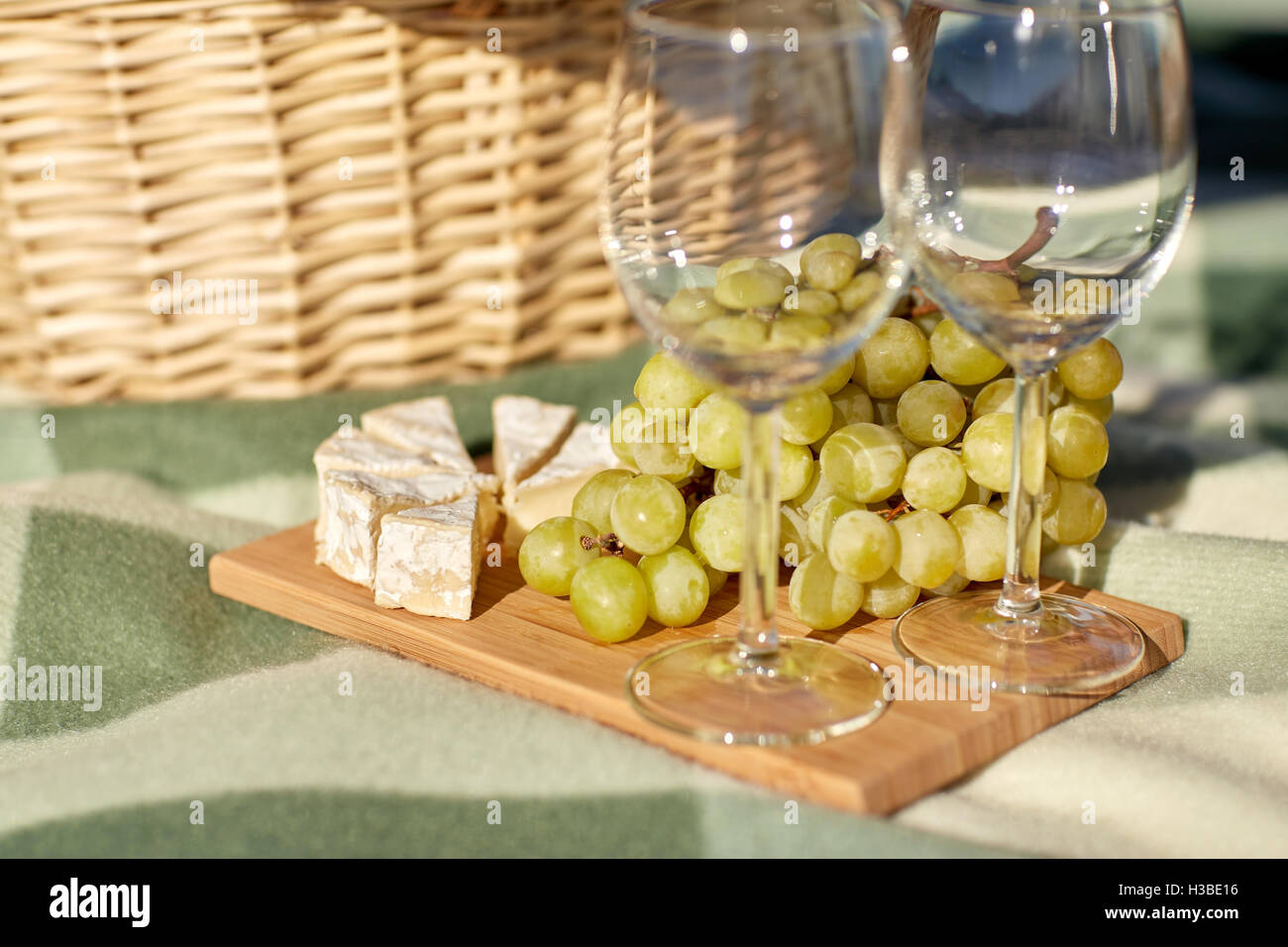 picnic basket with wine glasses, grapes and cheese Stock Photo Alamy