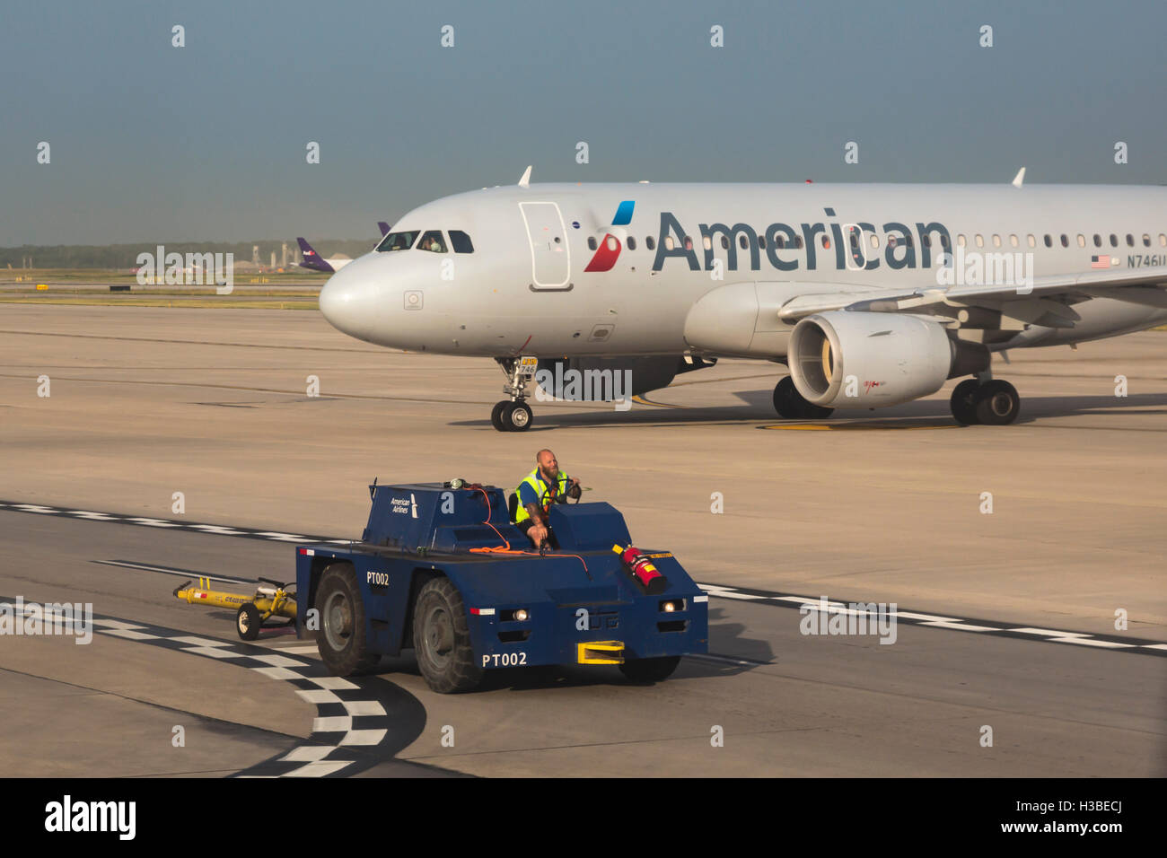 Detroit Michigan A Worker Drives A Tug Past An American Airlines Stock Photo Alamy