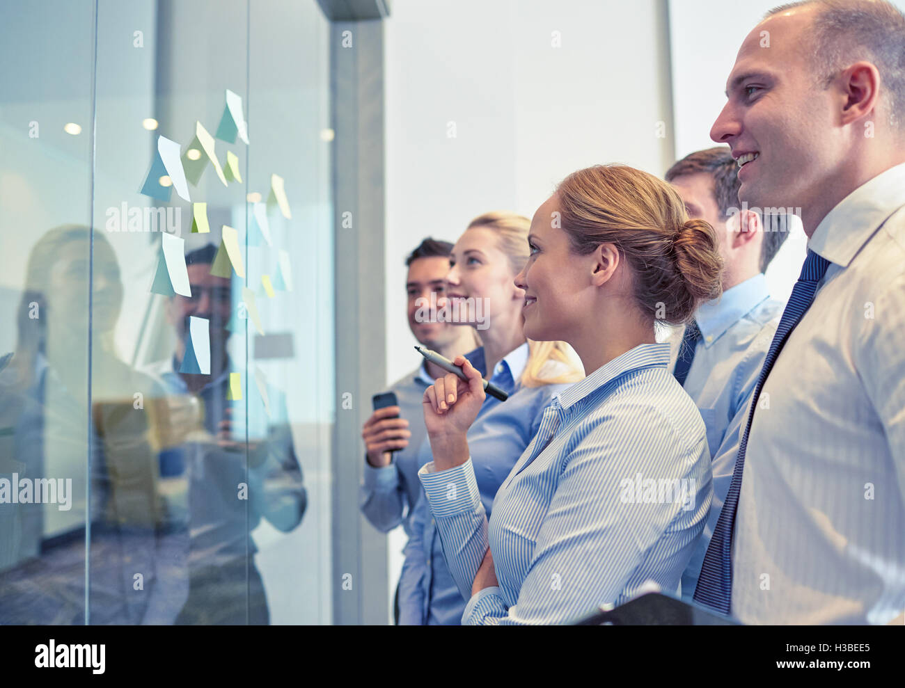 smiling business people with marker and stickers Stock Photo - Alamy