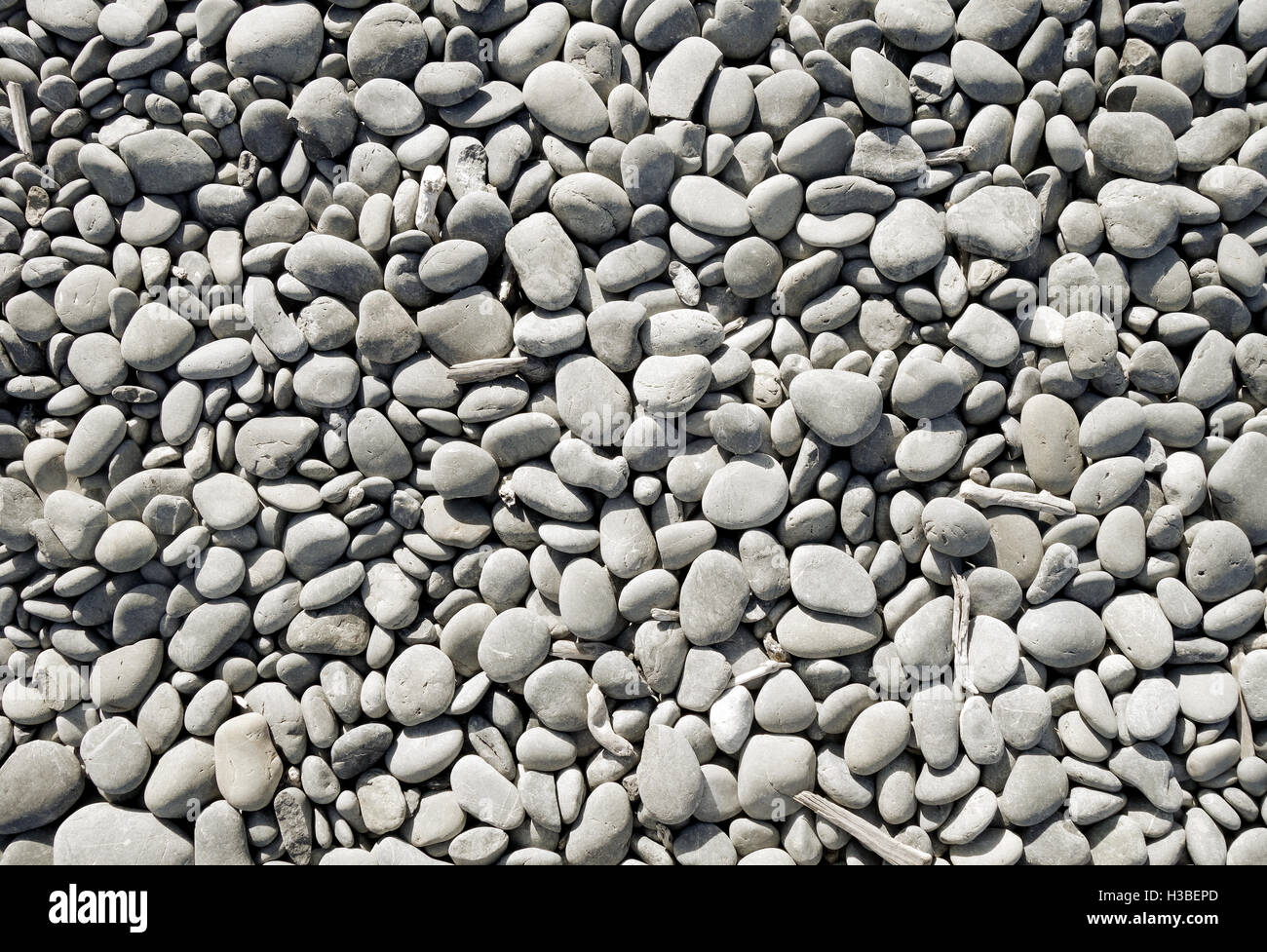pebbles on a beach background texture wallpaper Stock Photo