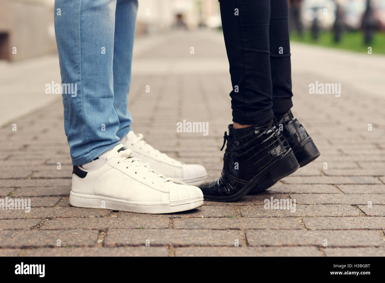 Close up of legs of kissing couple Stock Photo - Alamy
