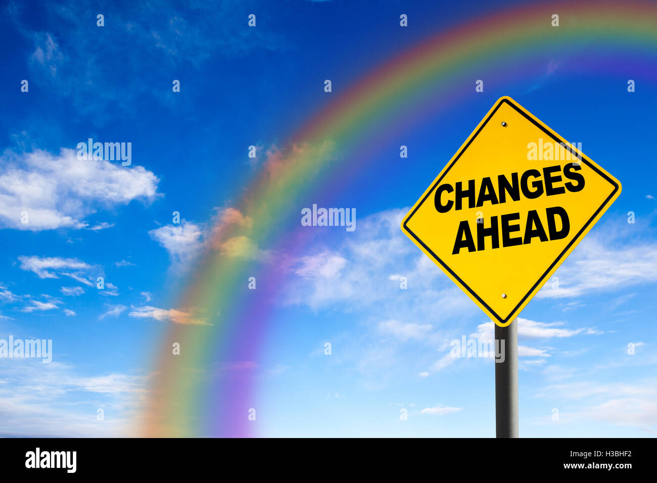 Changes Ahead sign against a blue sky with rainbow. Concept of situation change for the better. Stock Photo