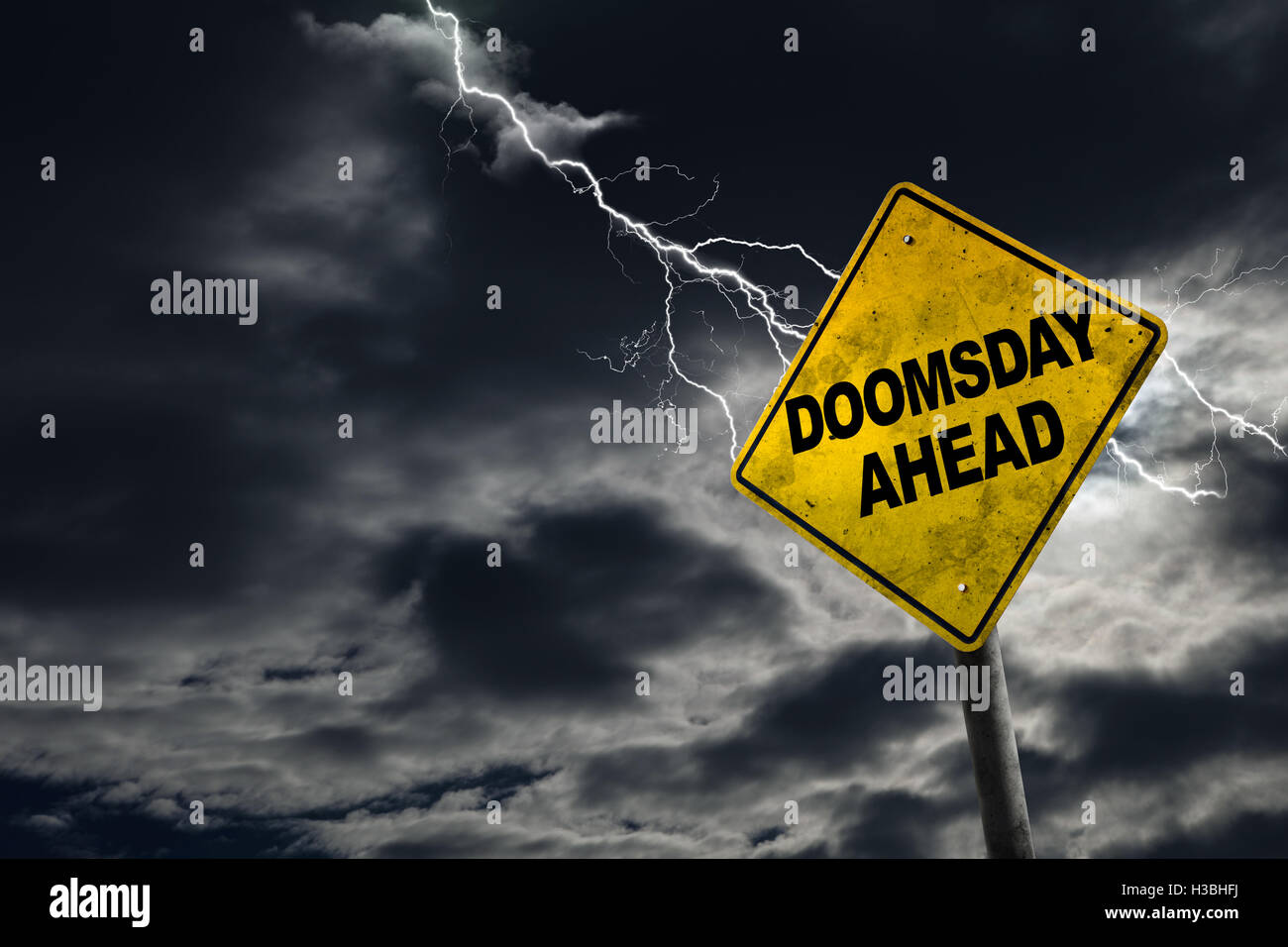 Doomsday sign against a stormy background with lightning and copy space. Dirty and angled sign adds to the drama. Stock Photo