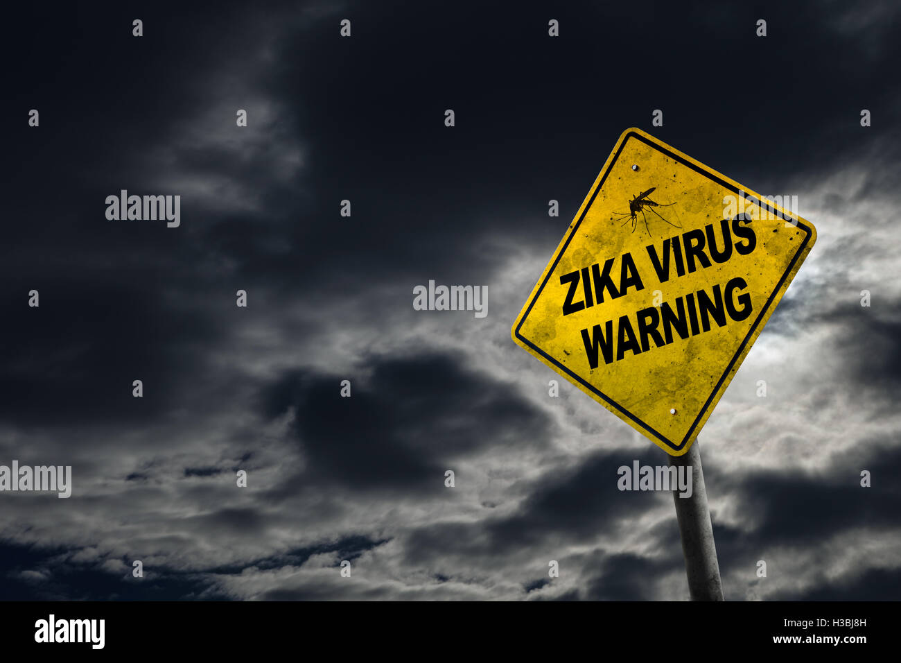 Zika virus warning sign against a stormy background with dirty and angled sign for drama. Stock Photo