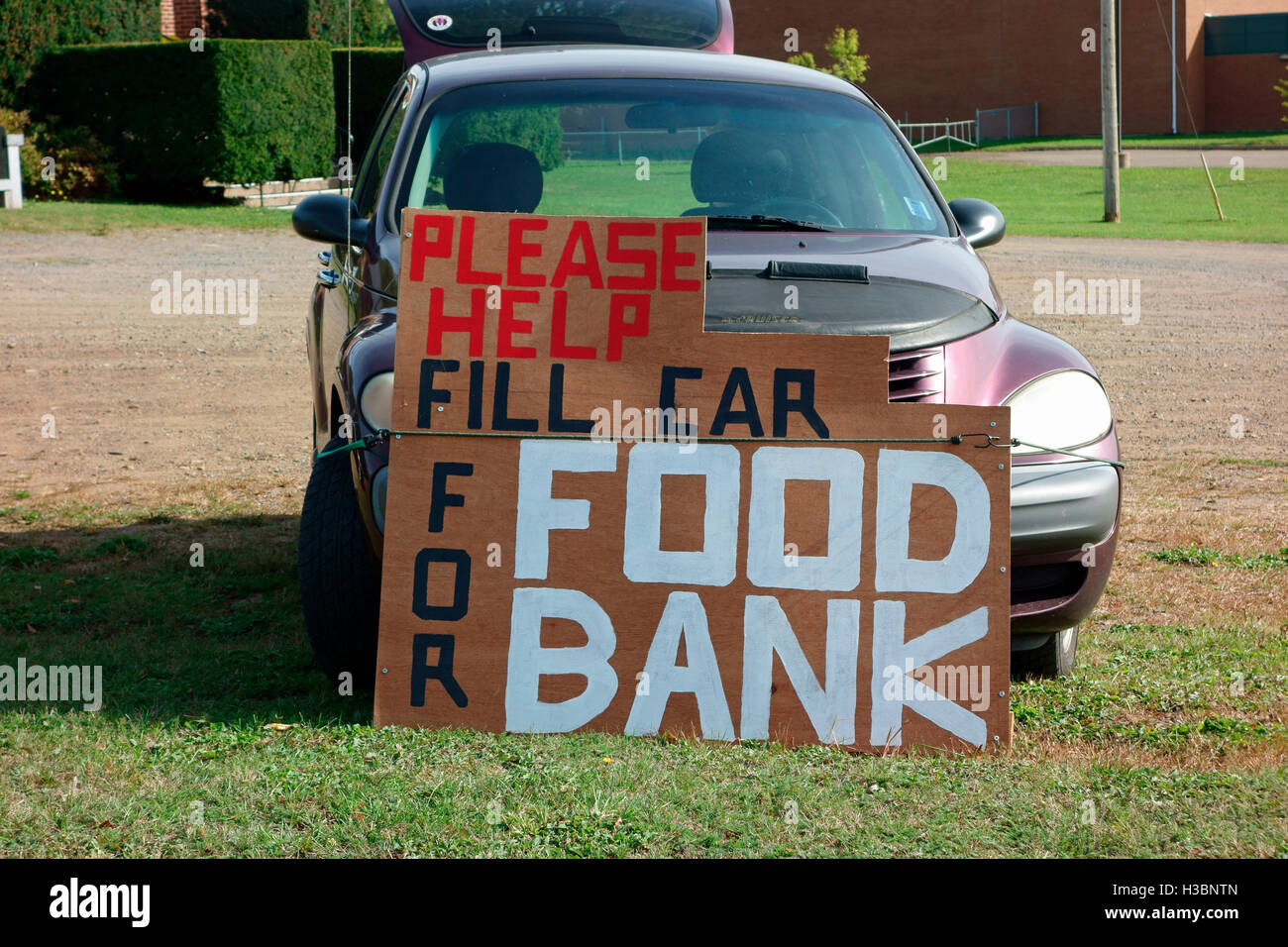A sign that says Please help Fill Car For Food bank Foodbank Stock Photo