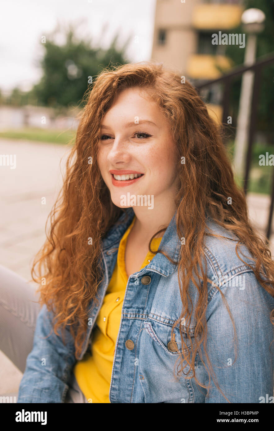 Portrait of a young redhead woman smiling Stock Photo