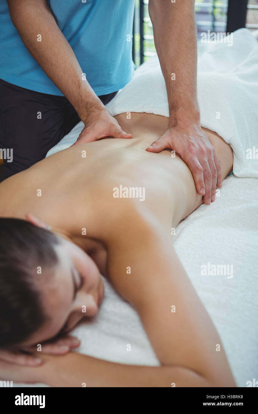 Physiotherapist giving physical therapy the back of a female patient Stock Photo