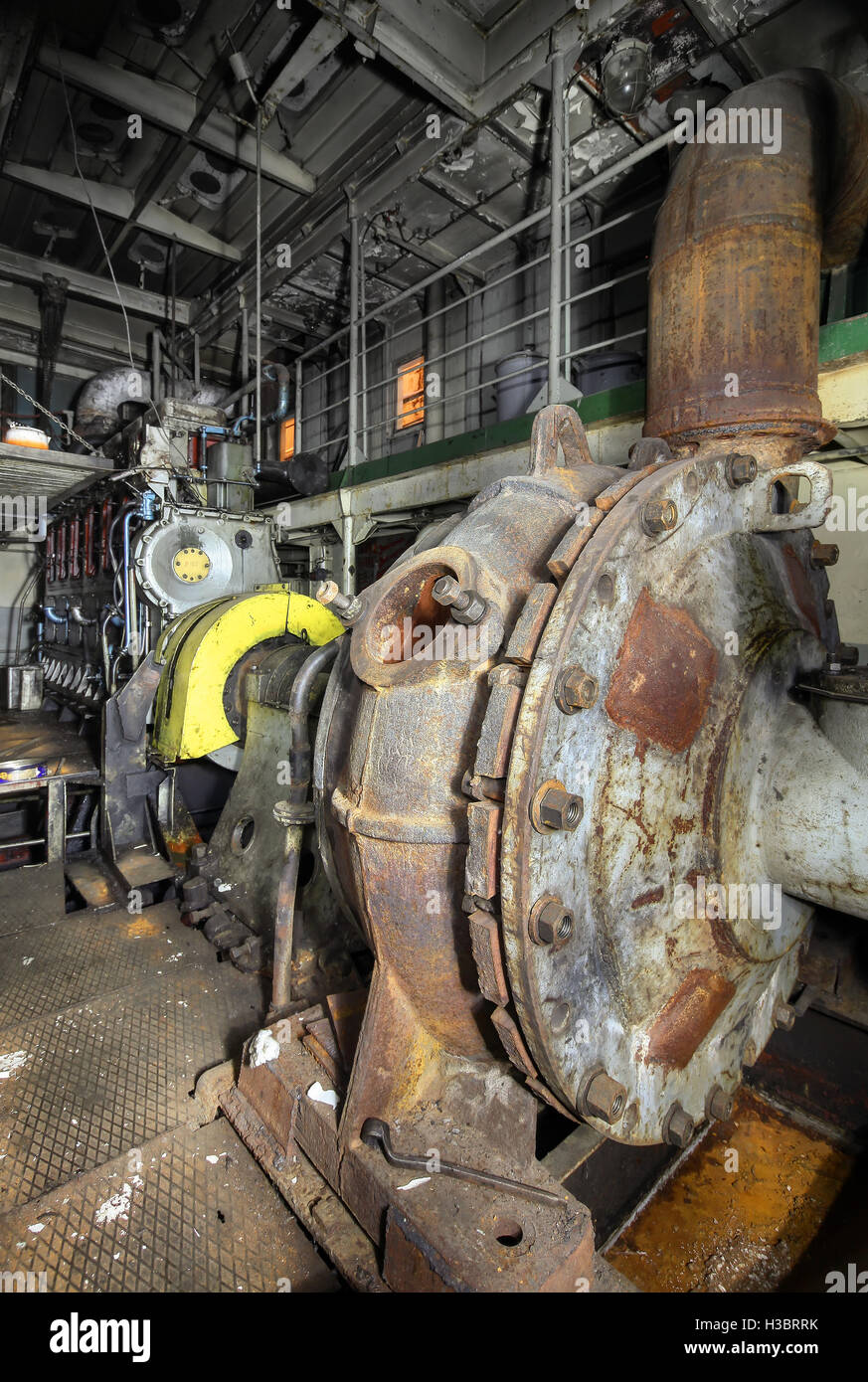 The ship's hold with diesel engine mounted on ship. Engine room on a old cargo boat ship. Stock Photo
