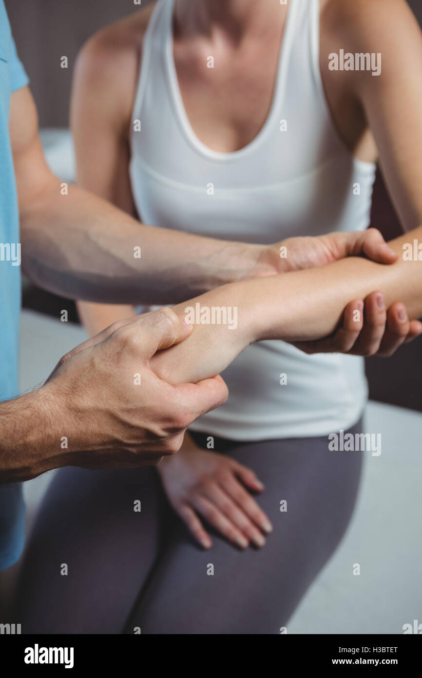 Physiotherapist massaging hand of a female patient Stock Photo