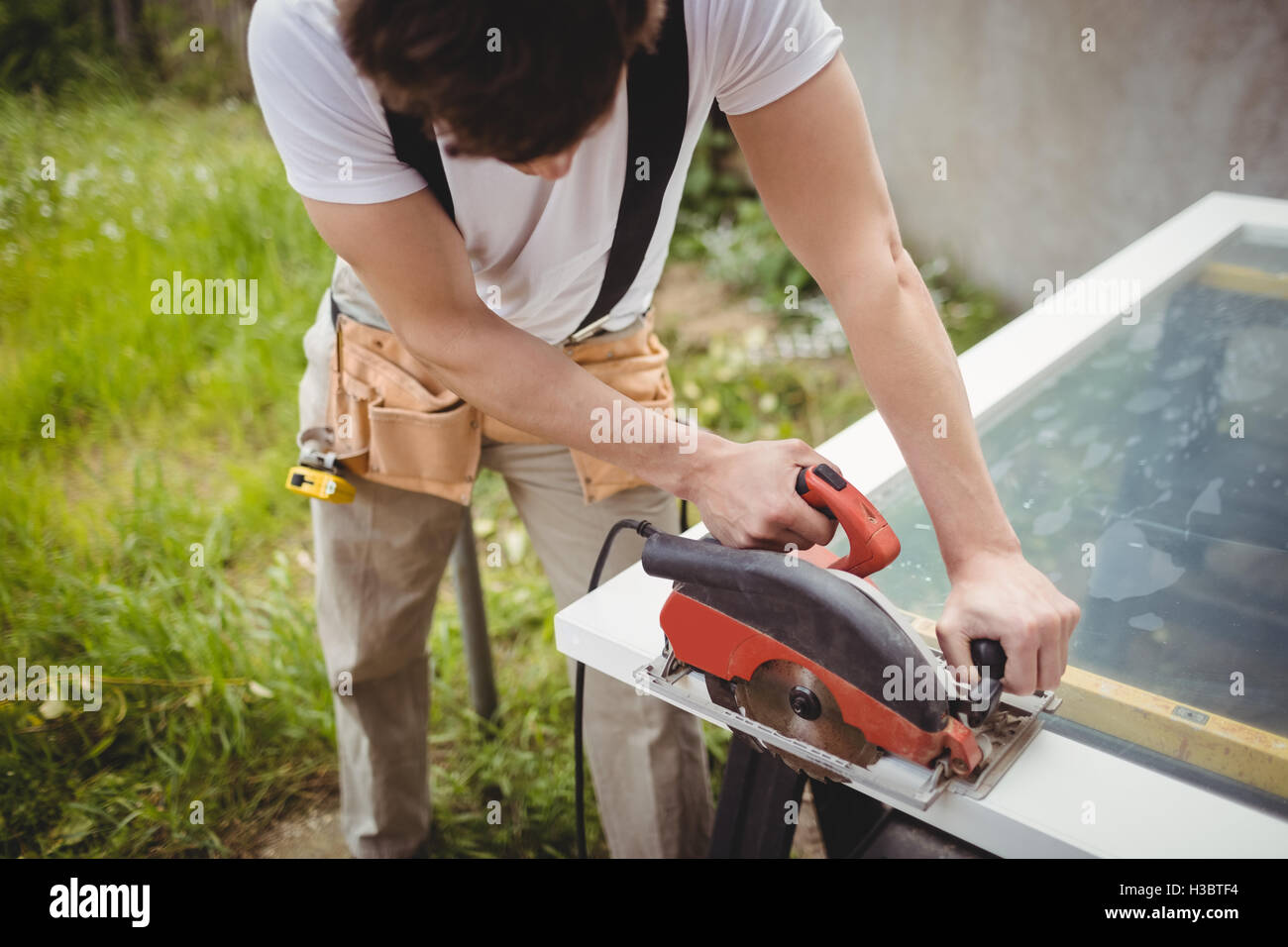 Carpenter cutting wooden frame from circular saw Stock Photo Alamy