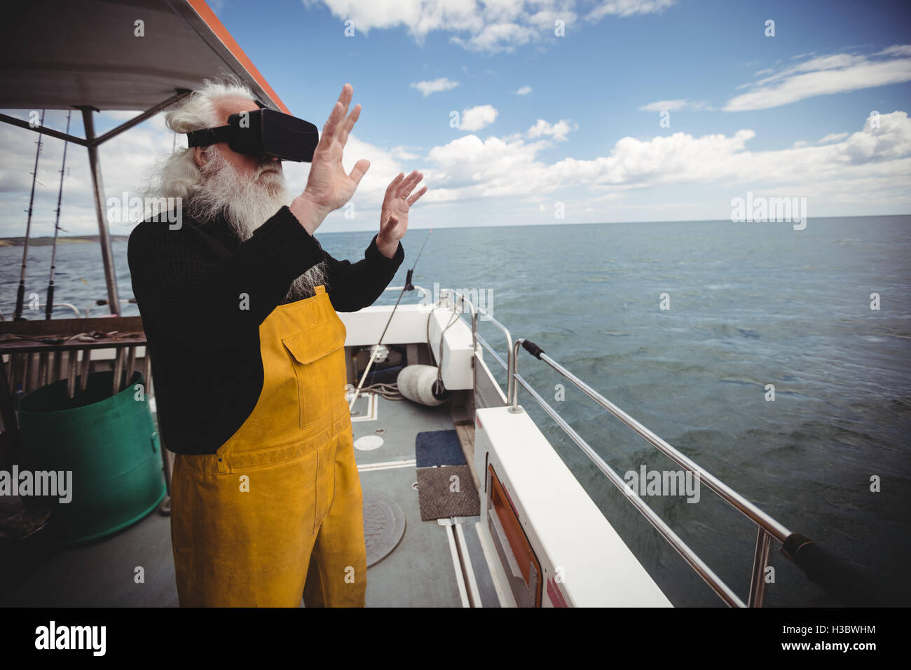 Fisherman using virtual reality glasses Stock Photo