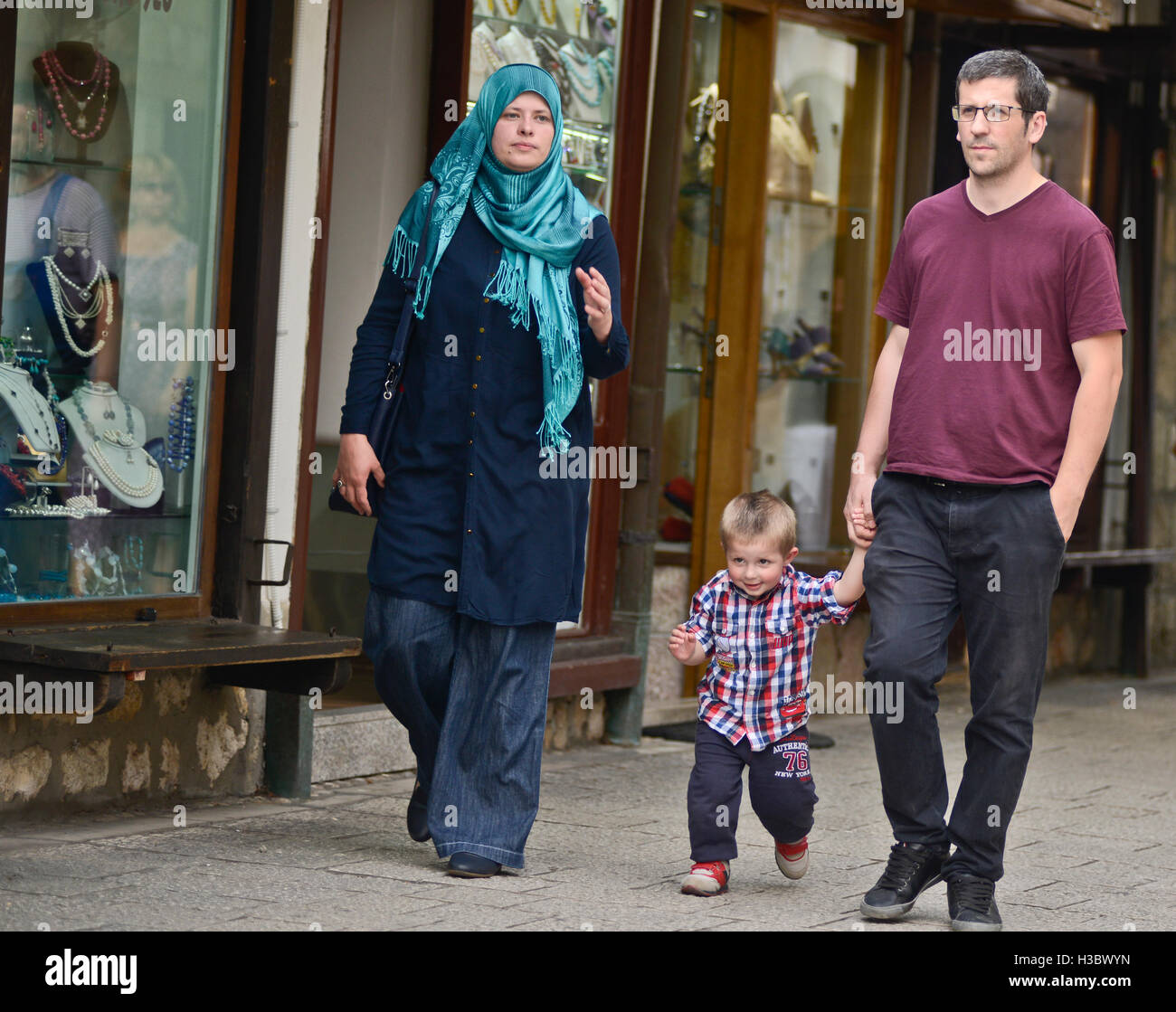 Muslim family walking down the streets of Sarajevo, Bosnia and Herzegovina Stock Photo