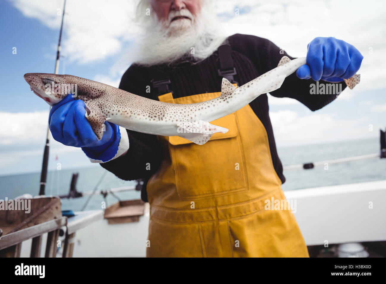 Fisherman holding fish Stock Photo