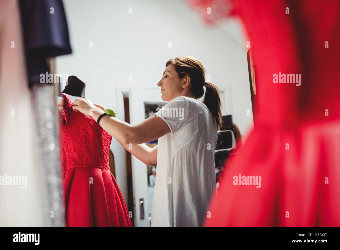 Creative designer adjusting the dress Stock Photo