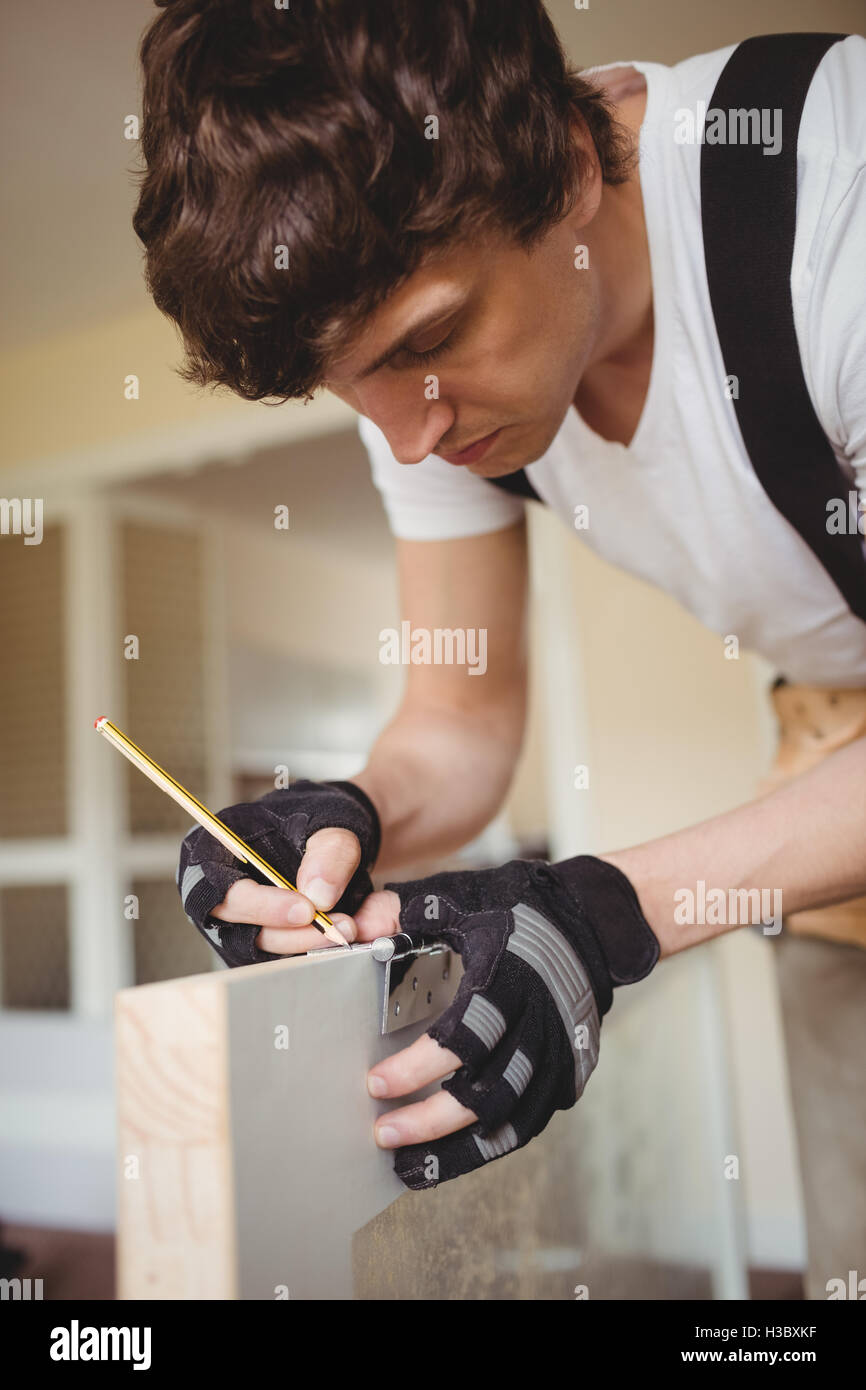 Carpenter marking on door with pencil Stock Photo Alamy