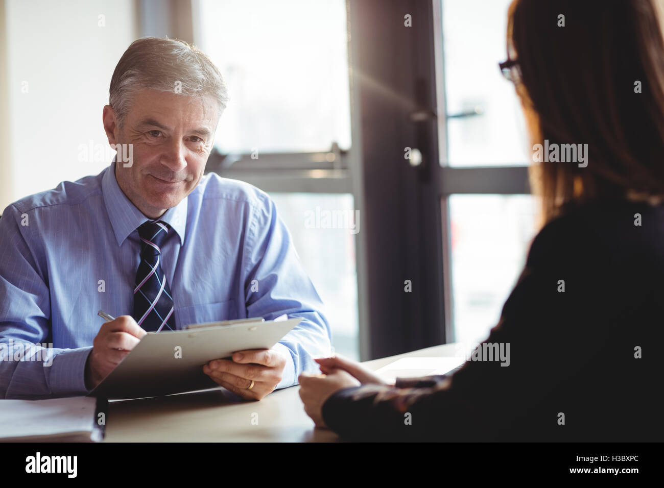 Businessman into discussion with colleague Stock Photo