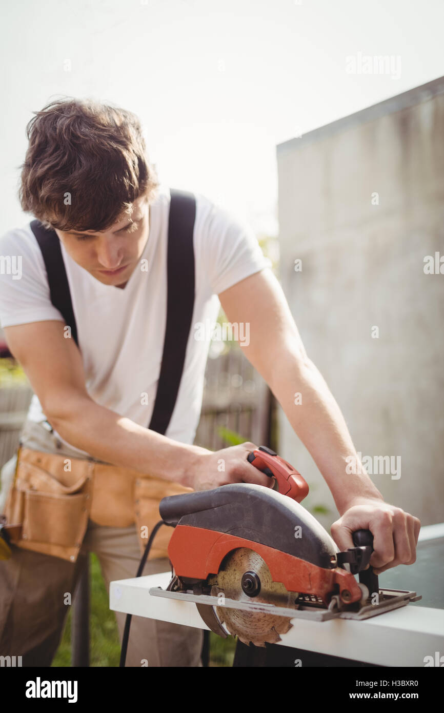 Carpenter cutting wooden frame from circular saw Stock Photo Alamy