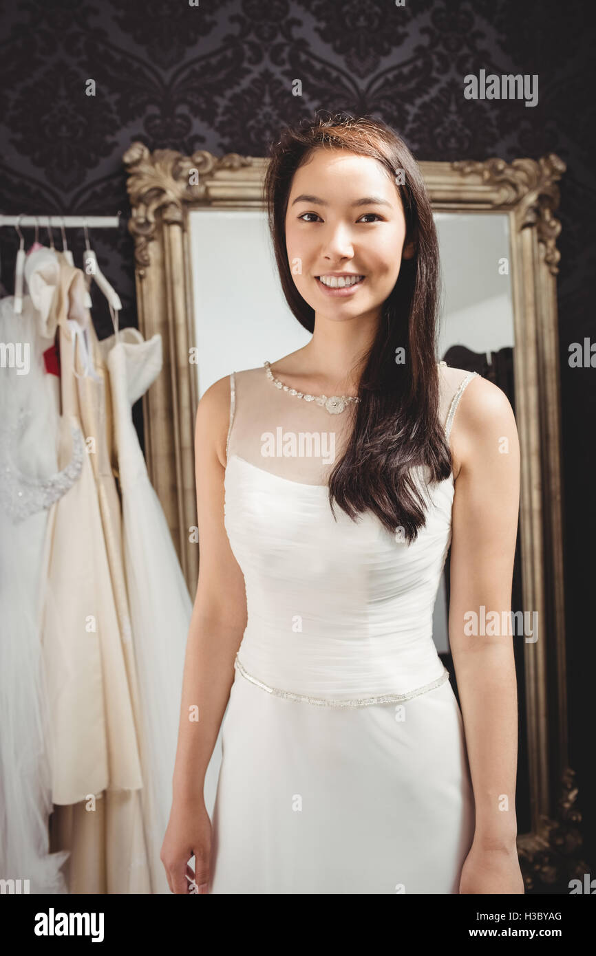Woman trying on wedding dress in a shop Stock Photo