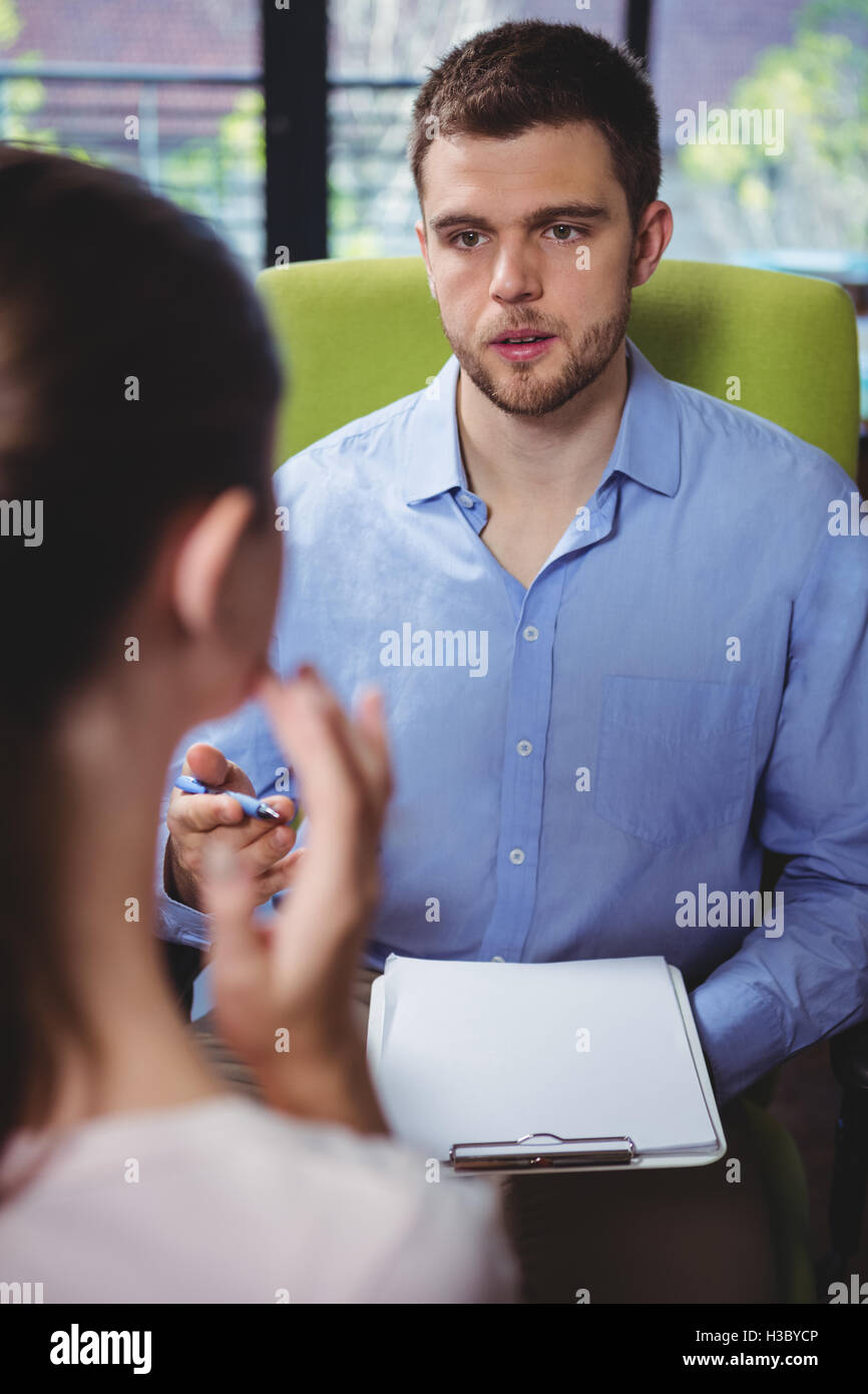 Physiotherapist explaining diagnosis to female patient Stock Photo