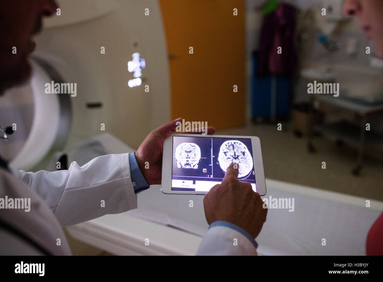 Doctor examining brain mri scan on digital tablet Stock Photo