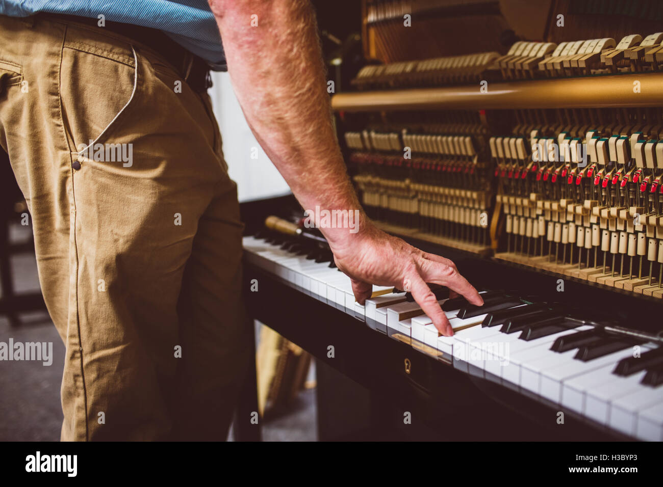 Piano technician repairing the piano Stock Photo