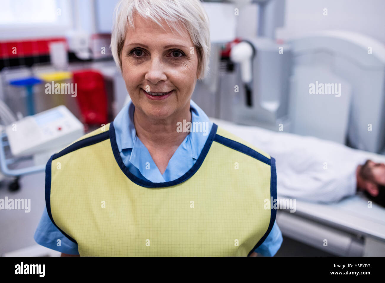 Portrait of smiling doctor standing in x-ray room Stock Photo