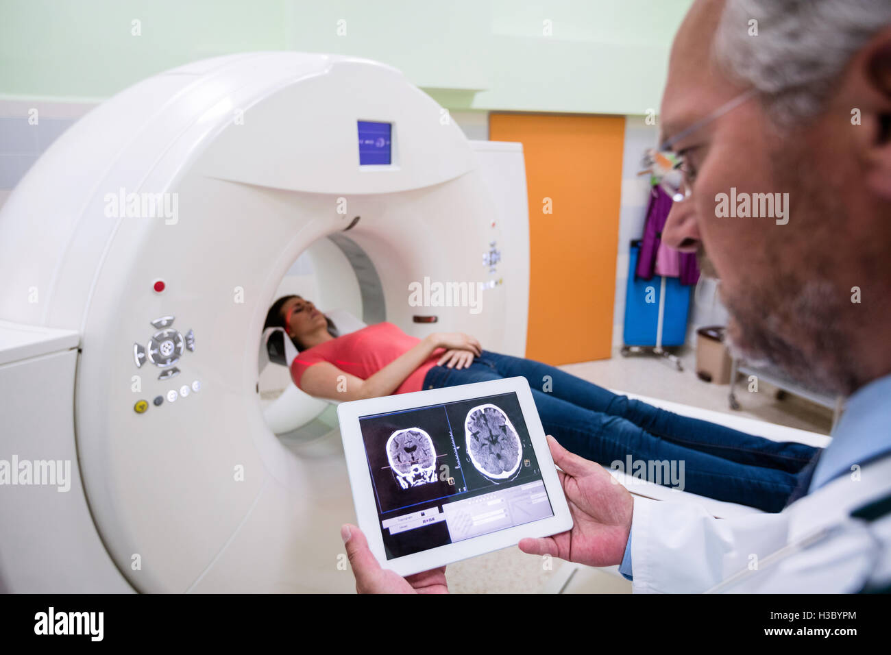 Doctor looking at brain mri scan on digital tablet Stock Photo