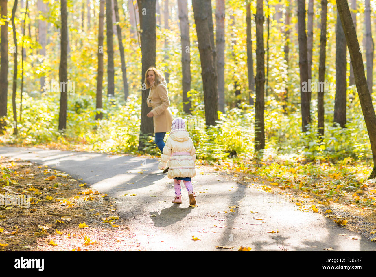 Young mother and her toddler girl have fun in autumn Stock Photo - Alamy