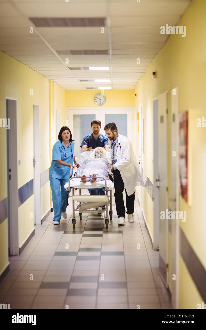 Doctor and nurse pushing a senior patient on stretcher Stock Photo